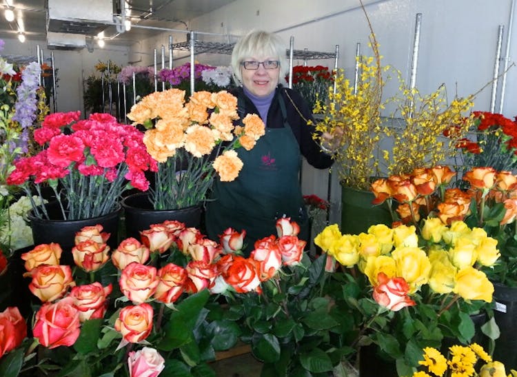 Store owner Marcia Schaaf gathers flowers for her next arrangement